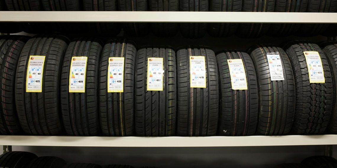 black leather belt on white wooden shelf