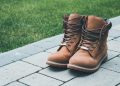 pair of brown boots on brick road near grass