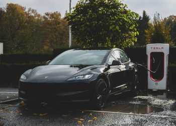 a tesla electric car charging at a charging station