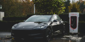 a tesla electric car charging at a charging station